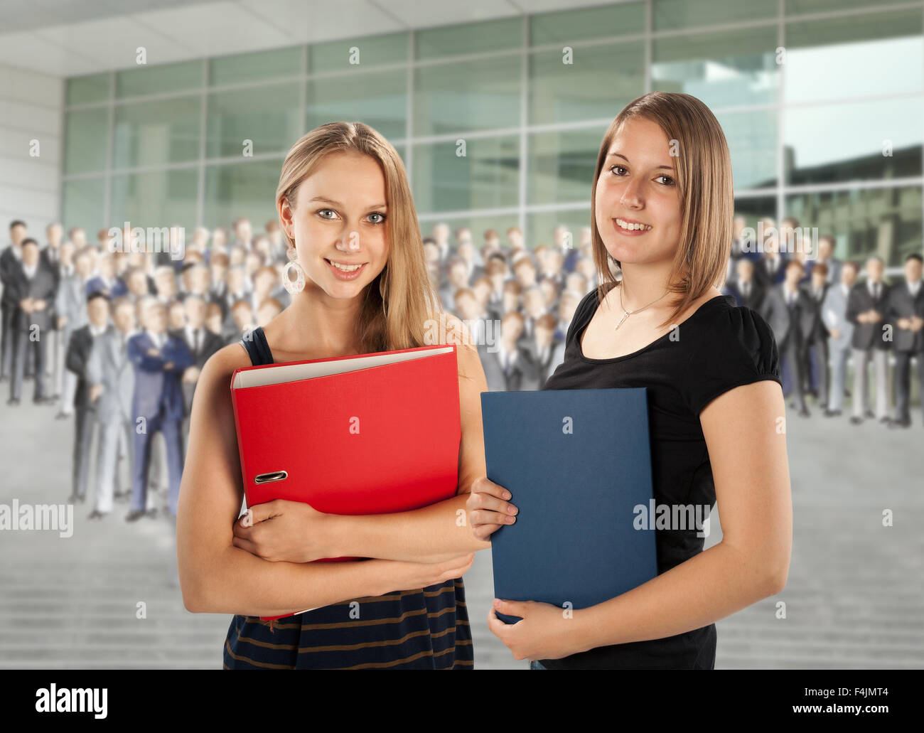Two young employees are faced with a group of colleagues. Stock Photo
