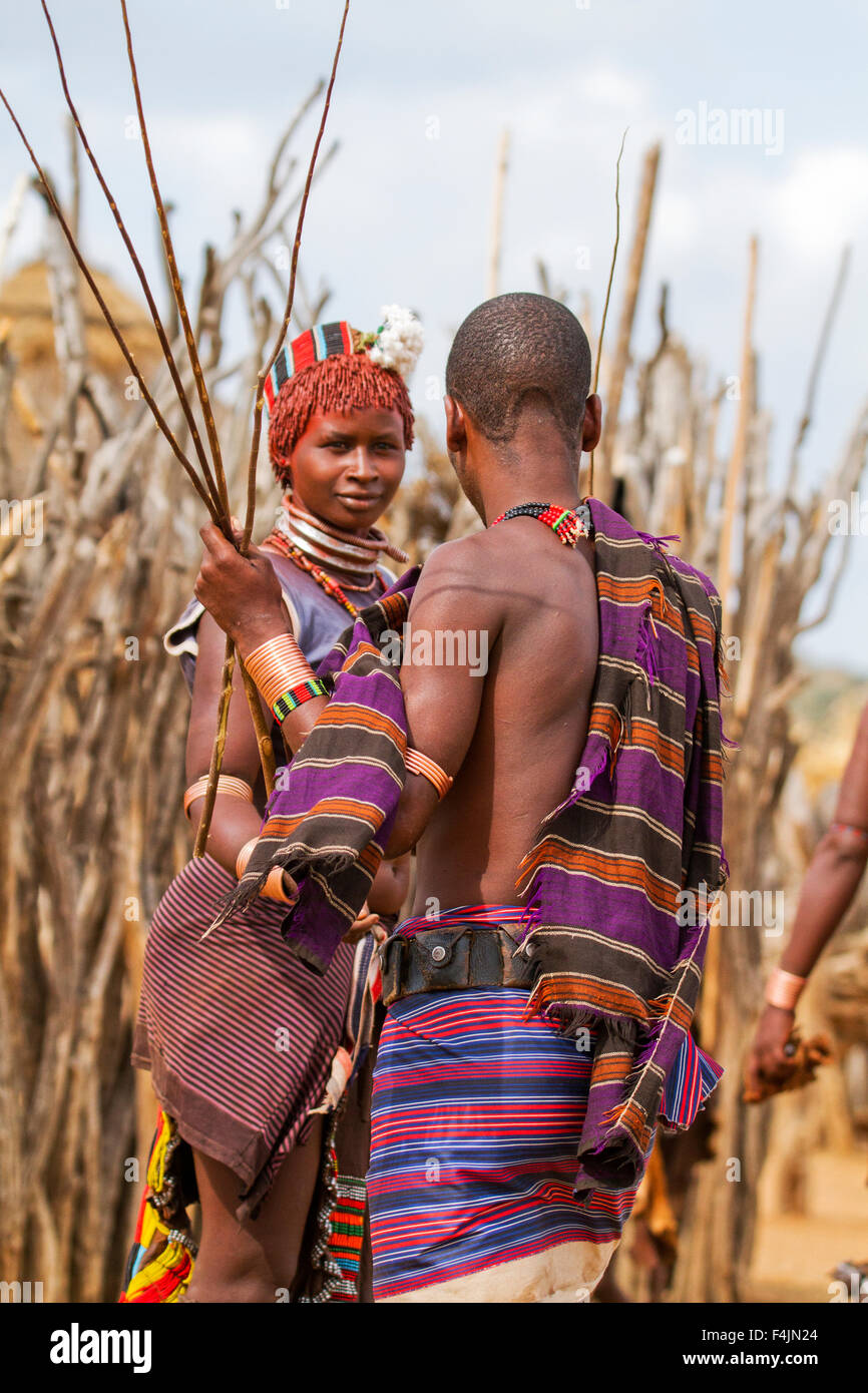 Man with reed whip ready to flog a female member at the Hamar tribe's  'Jumping of the Bull' ceremony. Omo Valley Ethiopia Stock Photo