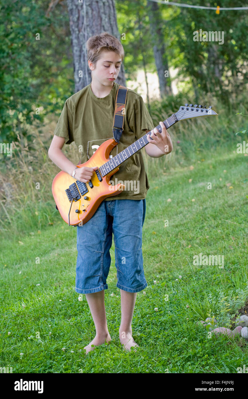 Sweden, Uppsala, teenage boy (14-15) playing Ibanez electric guitar Stock Photo