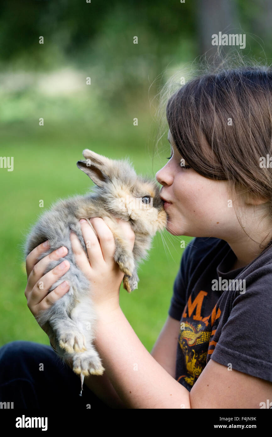 Sweden, Uppsala, girl kissing pet bunny Stock Photo