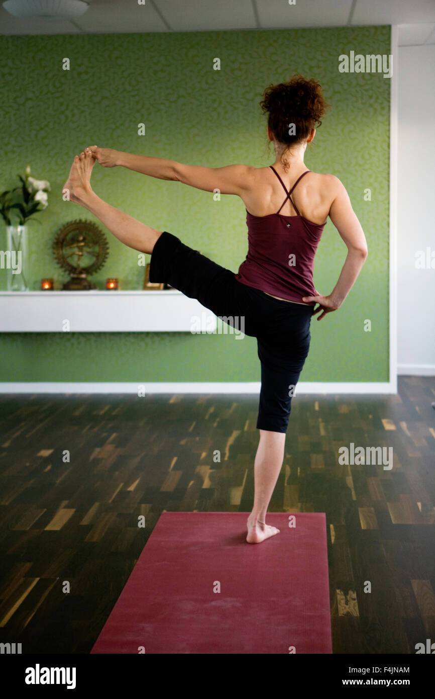 Sweden, Uppsala, rear view of mature woman practicing yoga Stock Photo ...