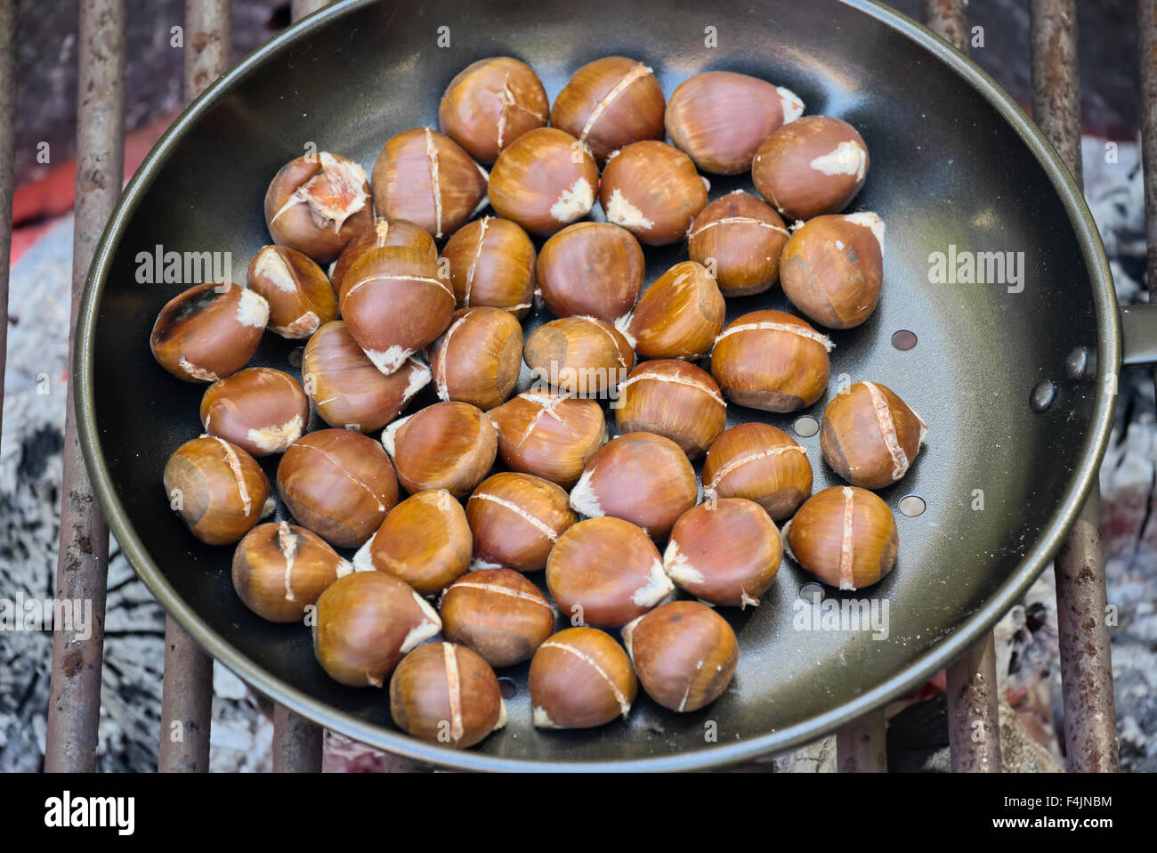 chestnuts roasting on an open fire Stock Photo
