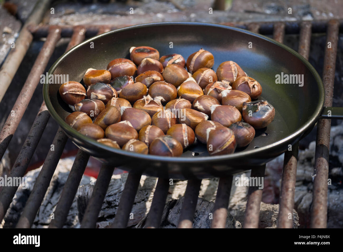 chestnuts roasting on an open fire Stock Photo