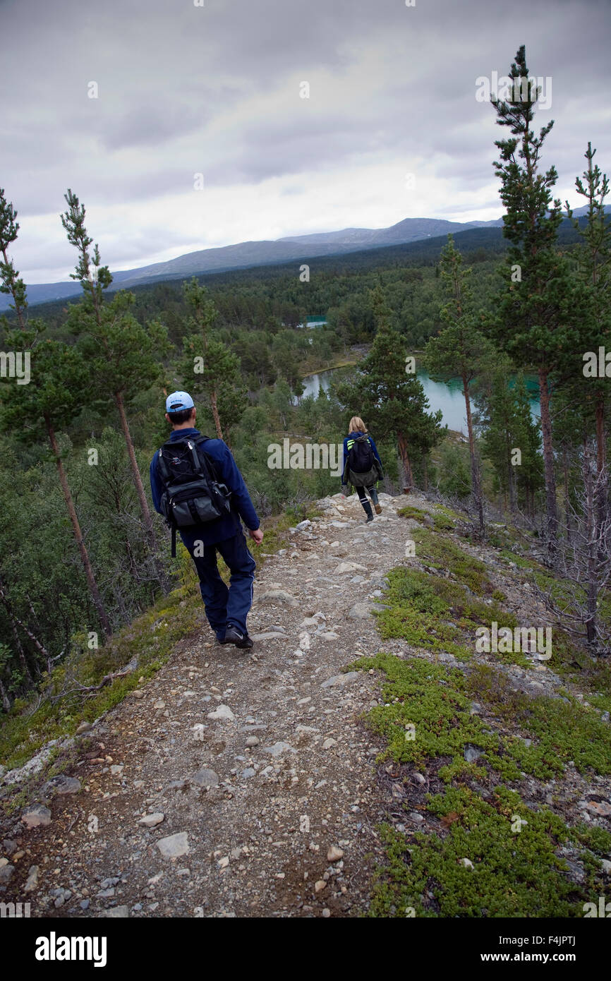 Two hikers hiking on mountains Stock Photo - Alamy