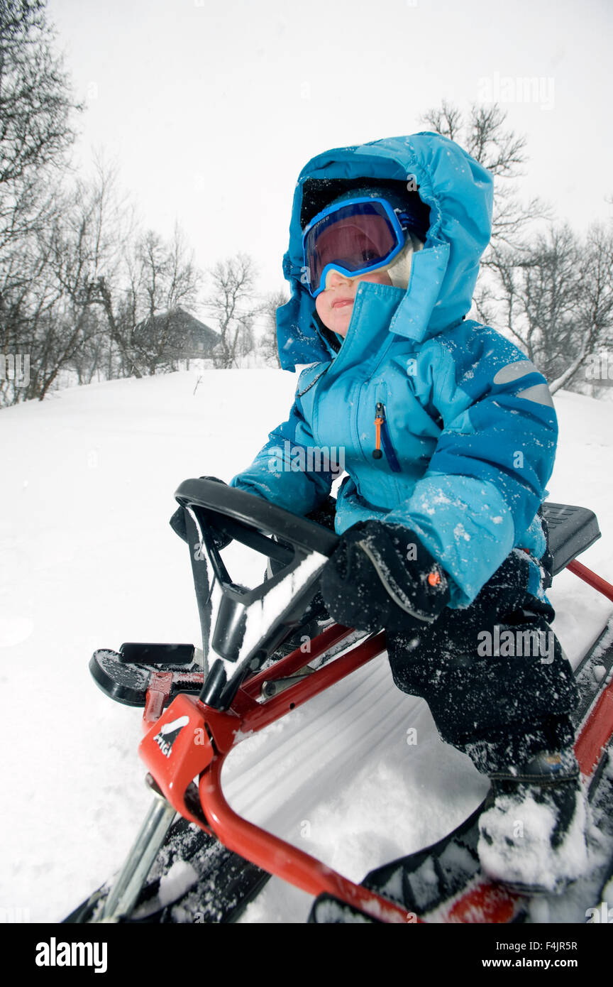 Girl riding snowmobile Stock Photo Alamy
