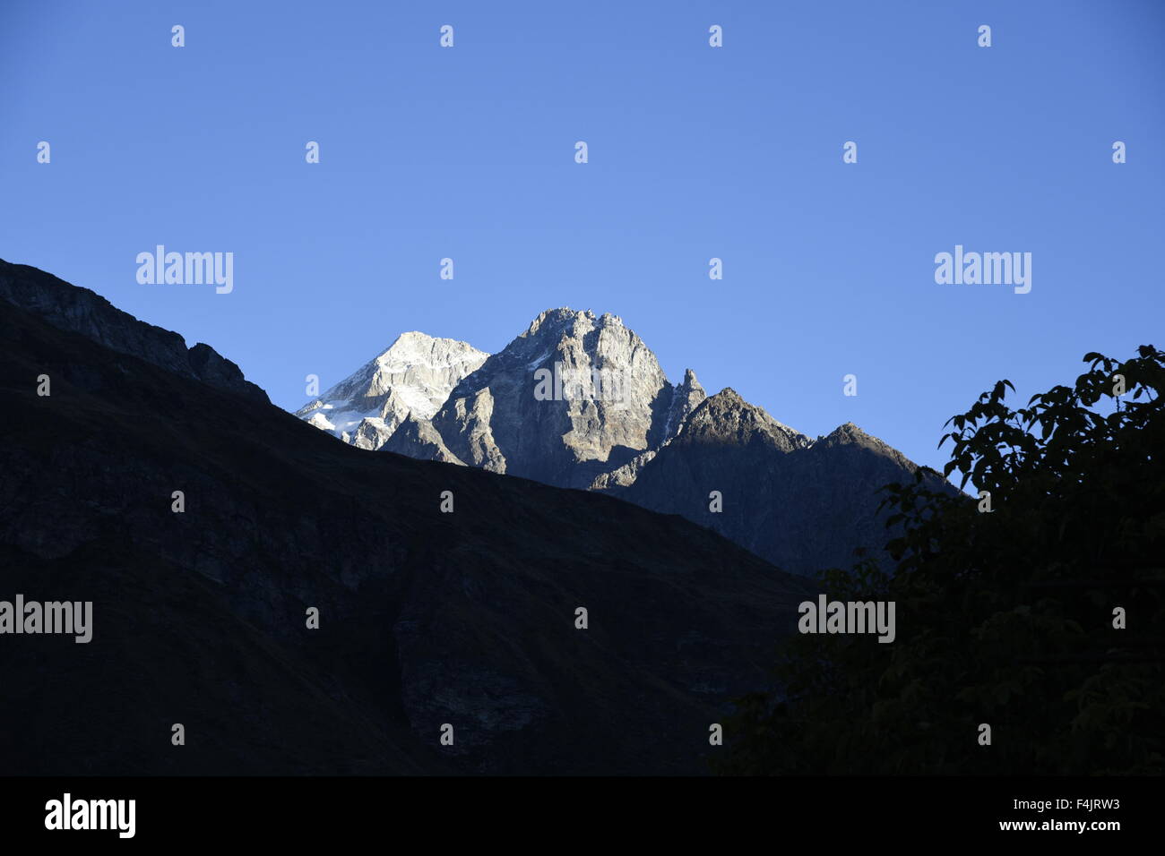 scenic India big mountain peak covered by heavy snow and clear blue sky near Badrinath kedarnath, Uttrakhand, India, Asia Stock Photo