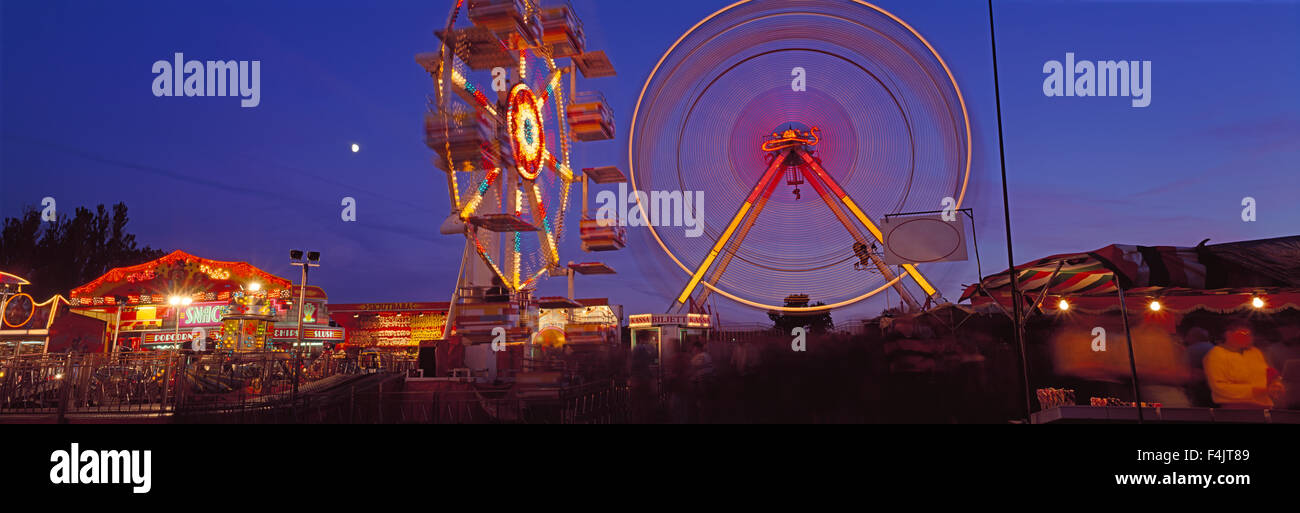 Big wheels in amusement park at night Stock Photo
