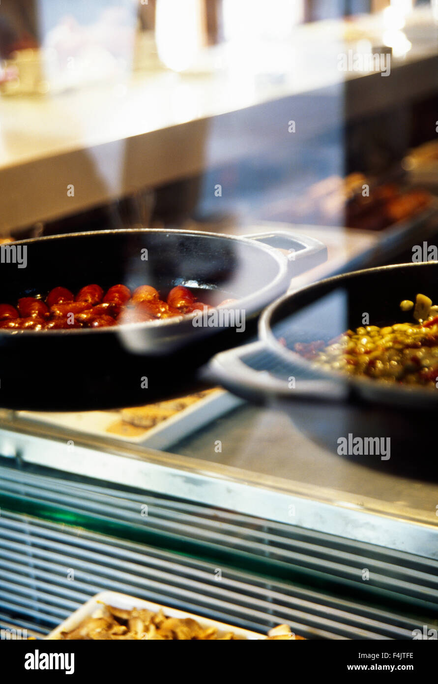 Food being prepared on frying pans Stock Photo