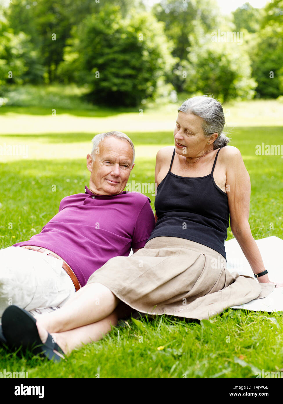 Senior couple relaxing in park Stock Photo - Alamy