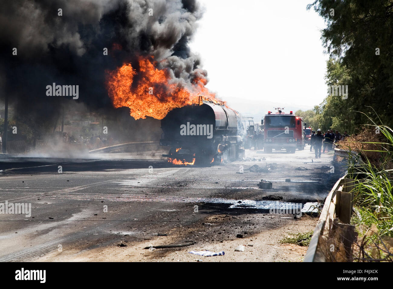 Truck burning in middle of highway Stock Photo