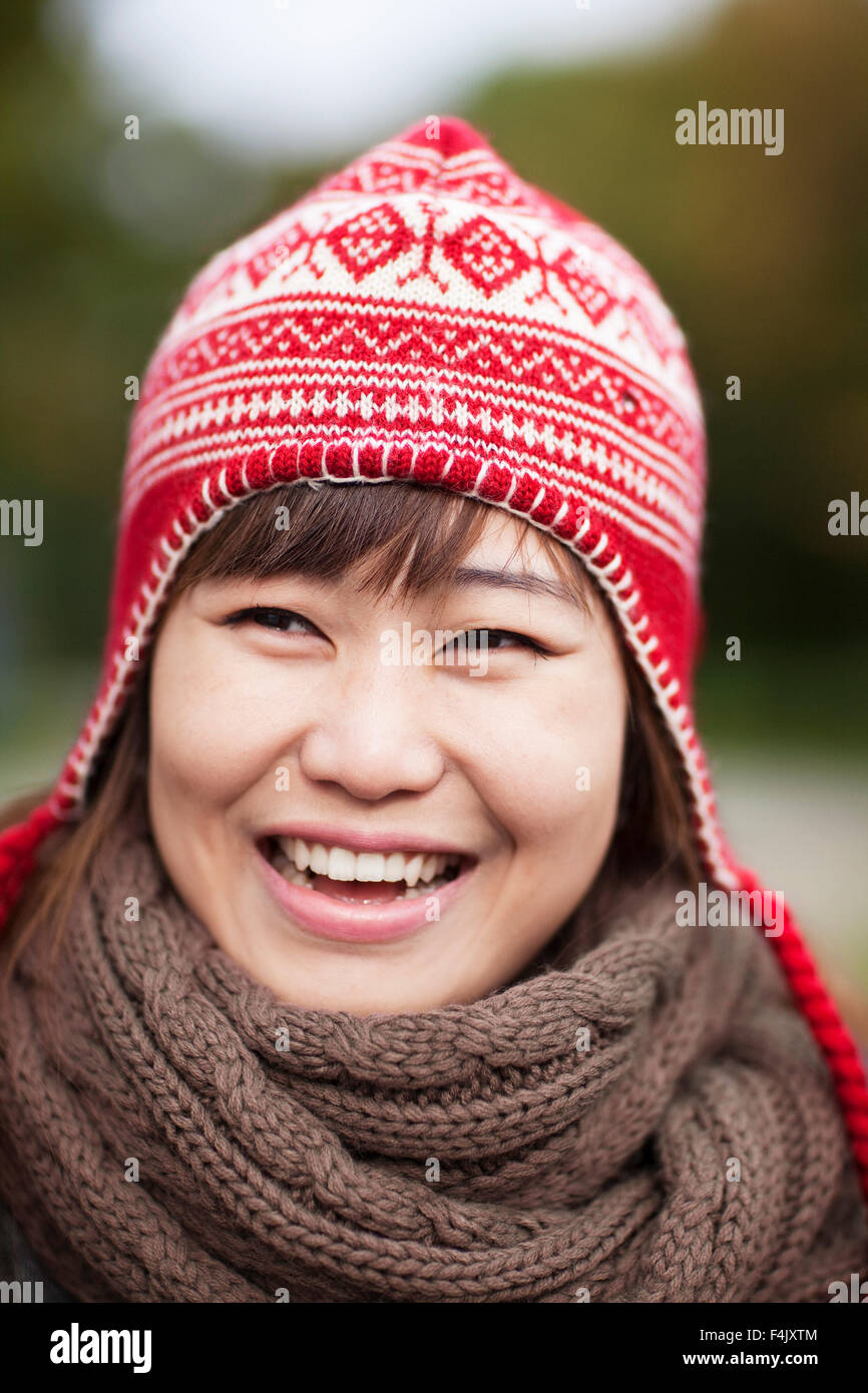 Portrait of happy young woman wearing wooly hat Stock Photo - Alamy