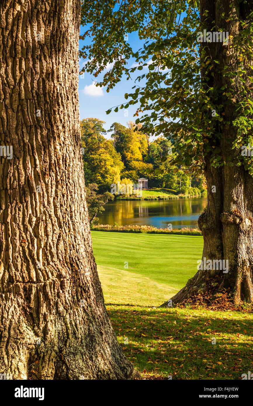 Autumnal view between trees of the lake and Doric Temple on the  Bowood Estate in Wiltshire. Stock Photo