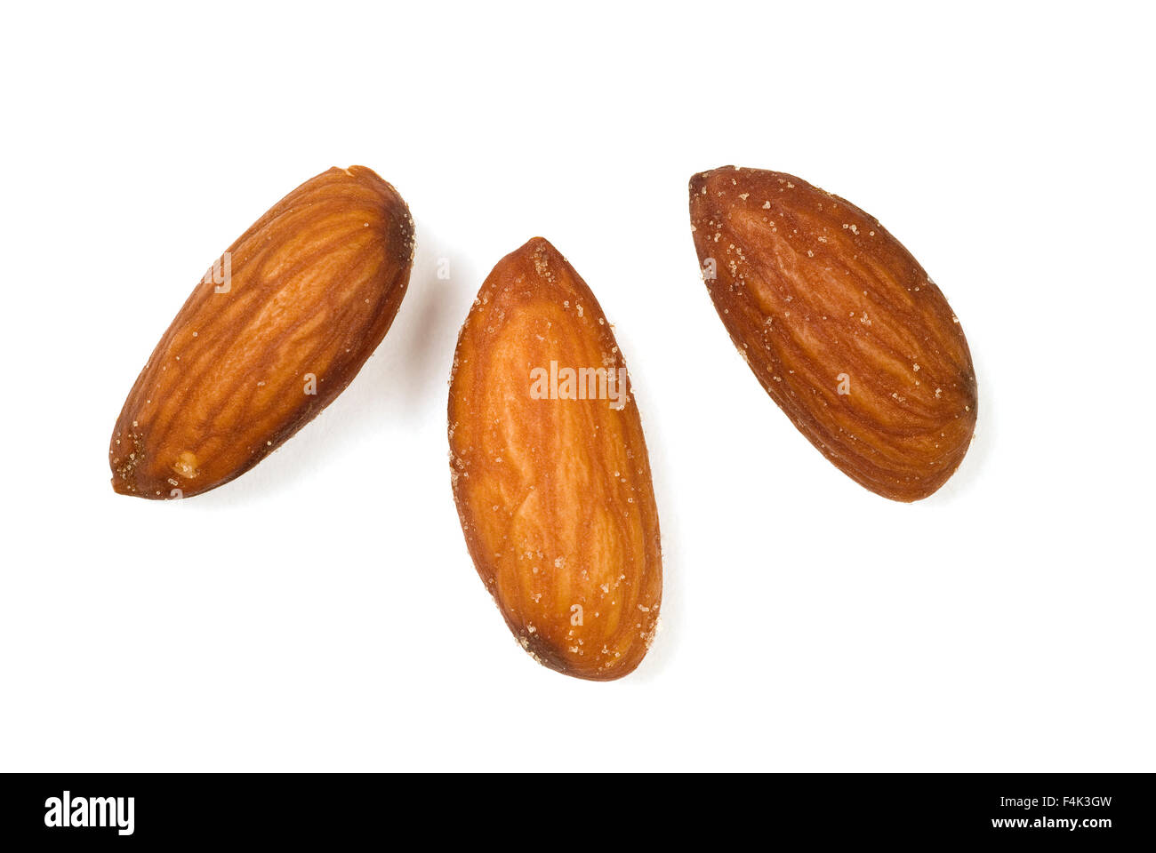 Three Salted Almonds Isolated on a white background. Stock Photo