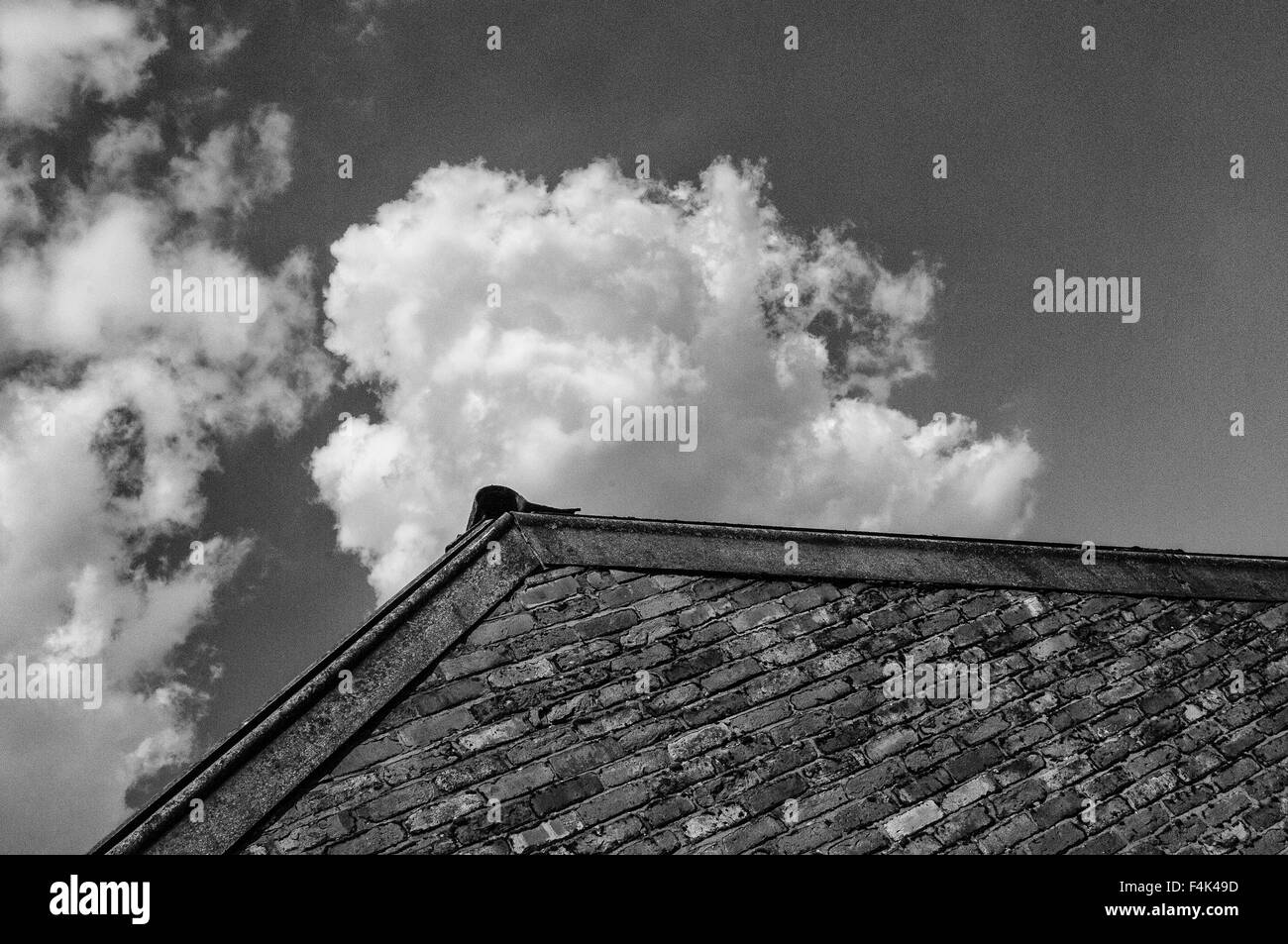 Clouds over gable end Stock Photo - Alamy