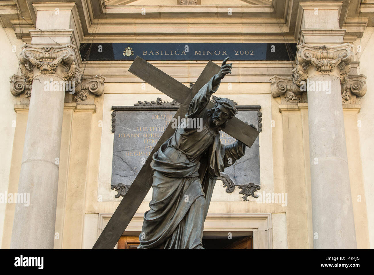 A statue of Jesus stands in front of Church of the Holy Cross Warsaw, Poland Stock Photo Alamy