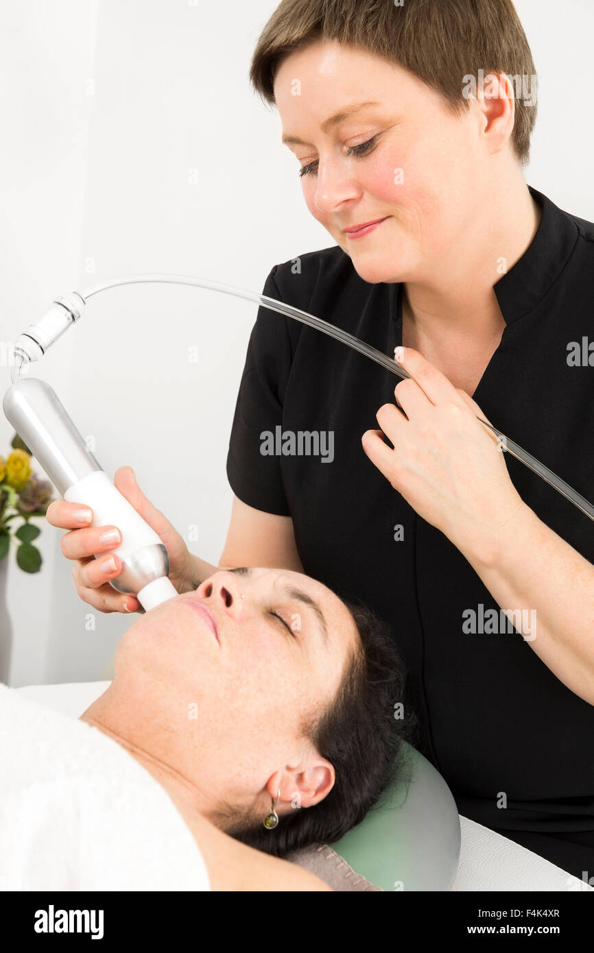 Customer get face treatments at beauty clinic Stock Photo