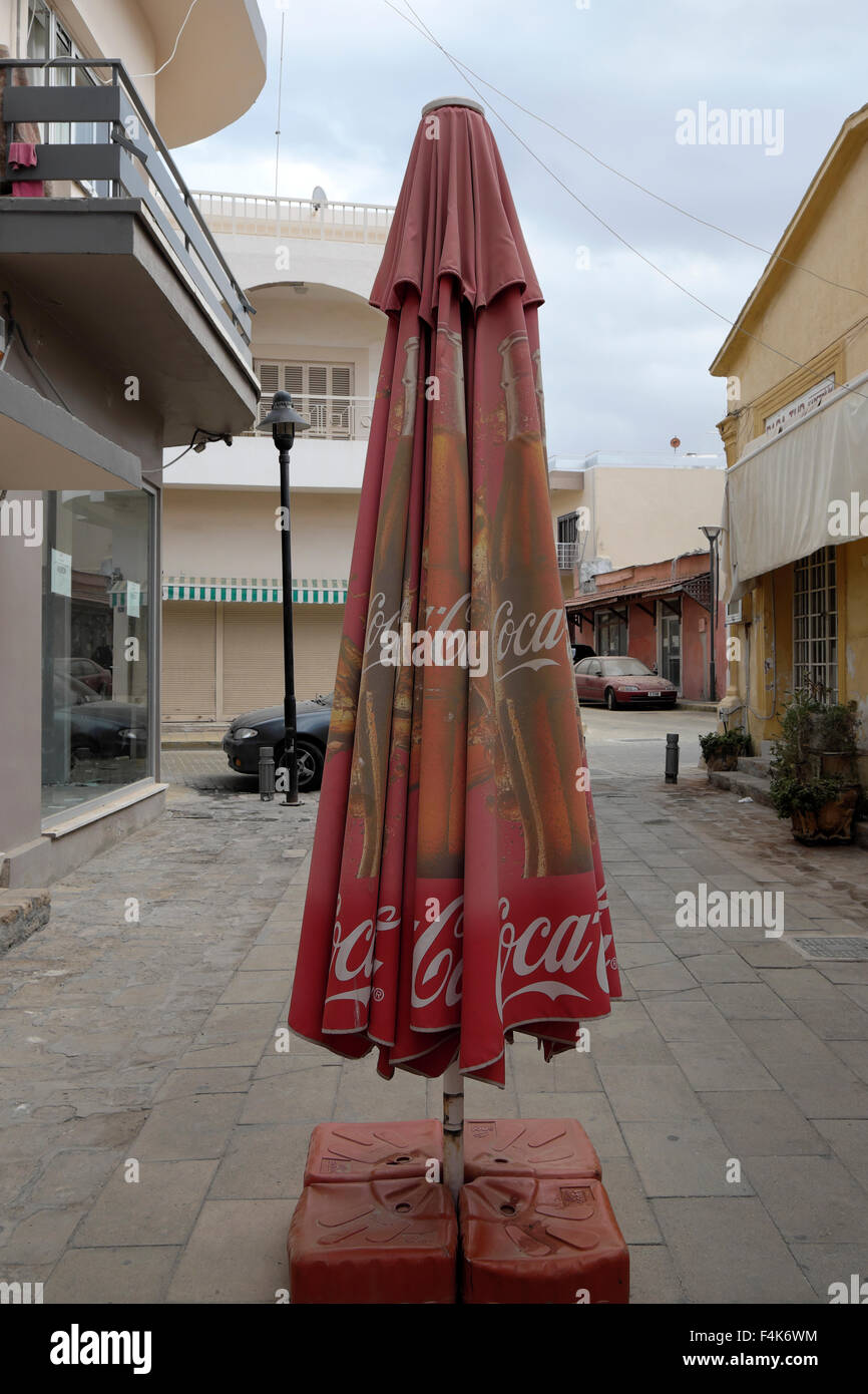 Collapsed Coca Cola umbrella on a street in Famagusta in Turkish North Cyprus  KATHY DEWITT Stock Photo