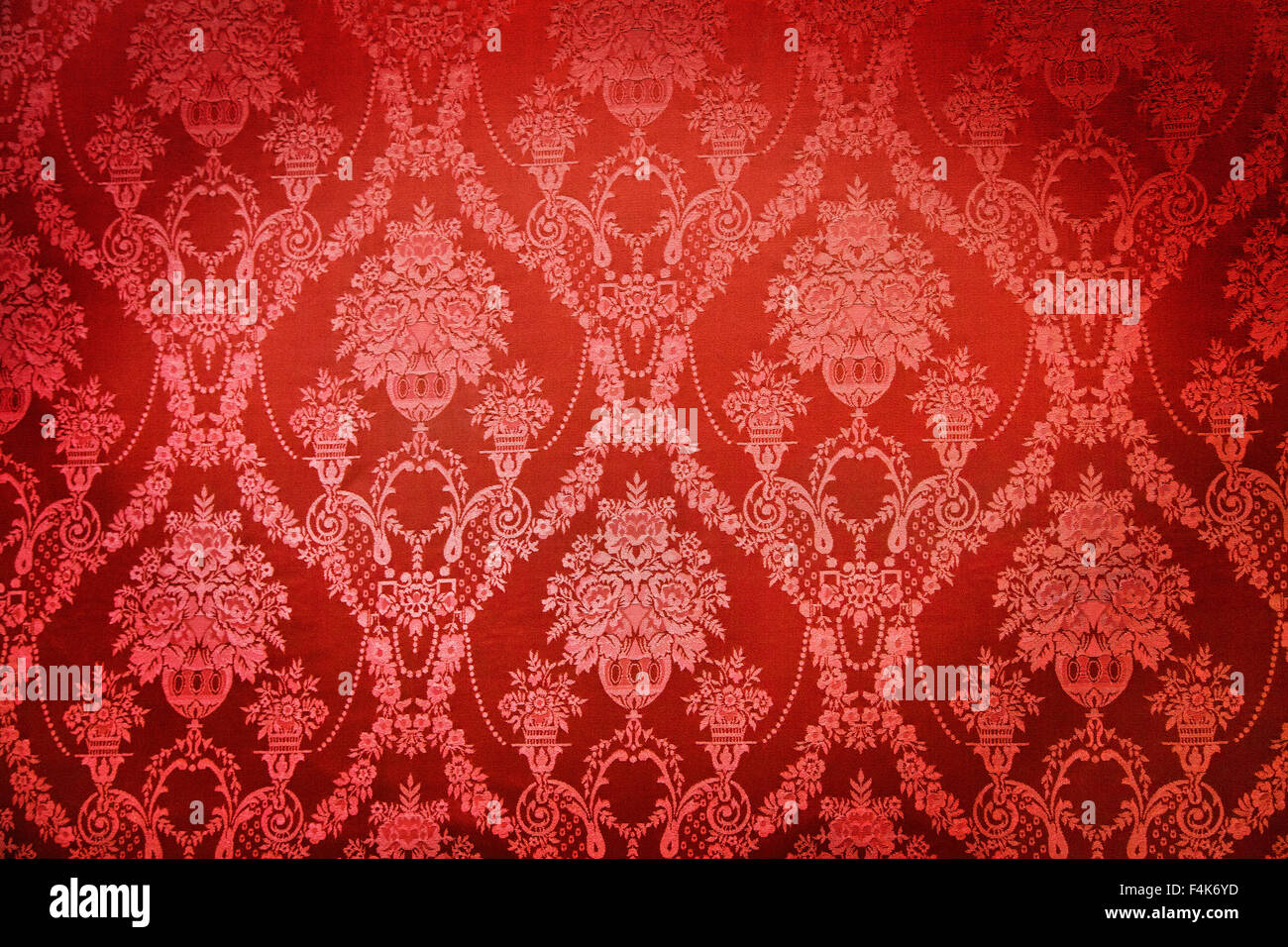 Old red textile wall covering in a palace Stock Photo