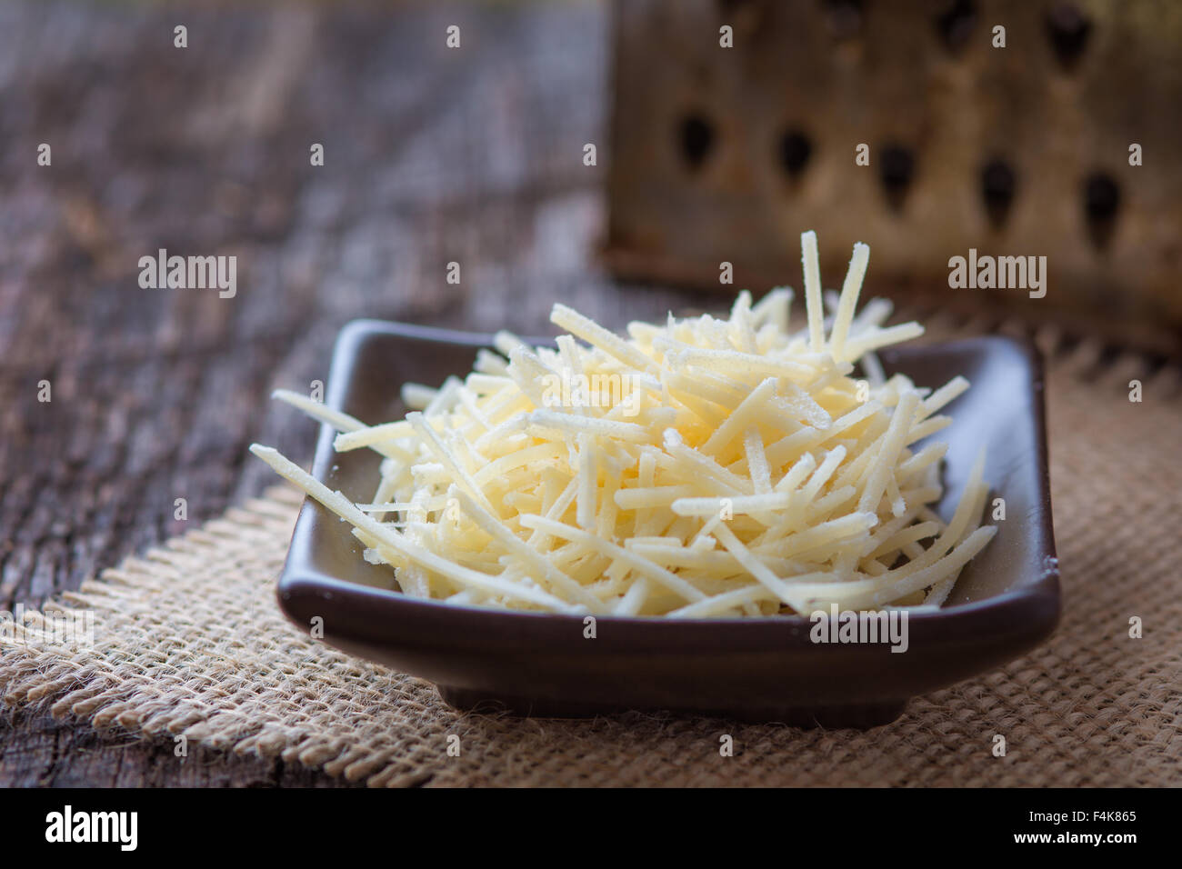 Parmesan cheese on burlap in rustic setting Stock Photo