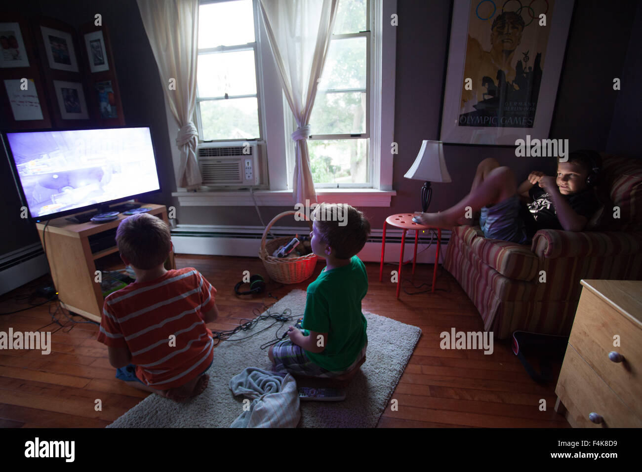 Three young Brothers play video games in their suburban Bedroom Stock Photo  - Alamy