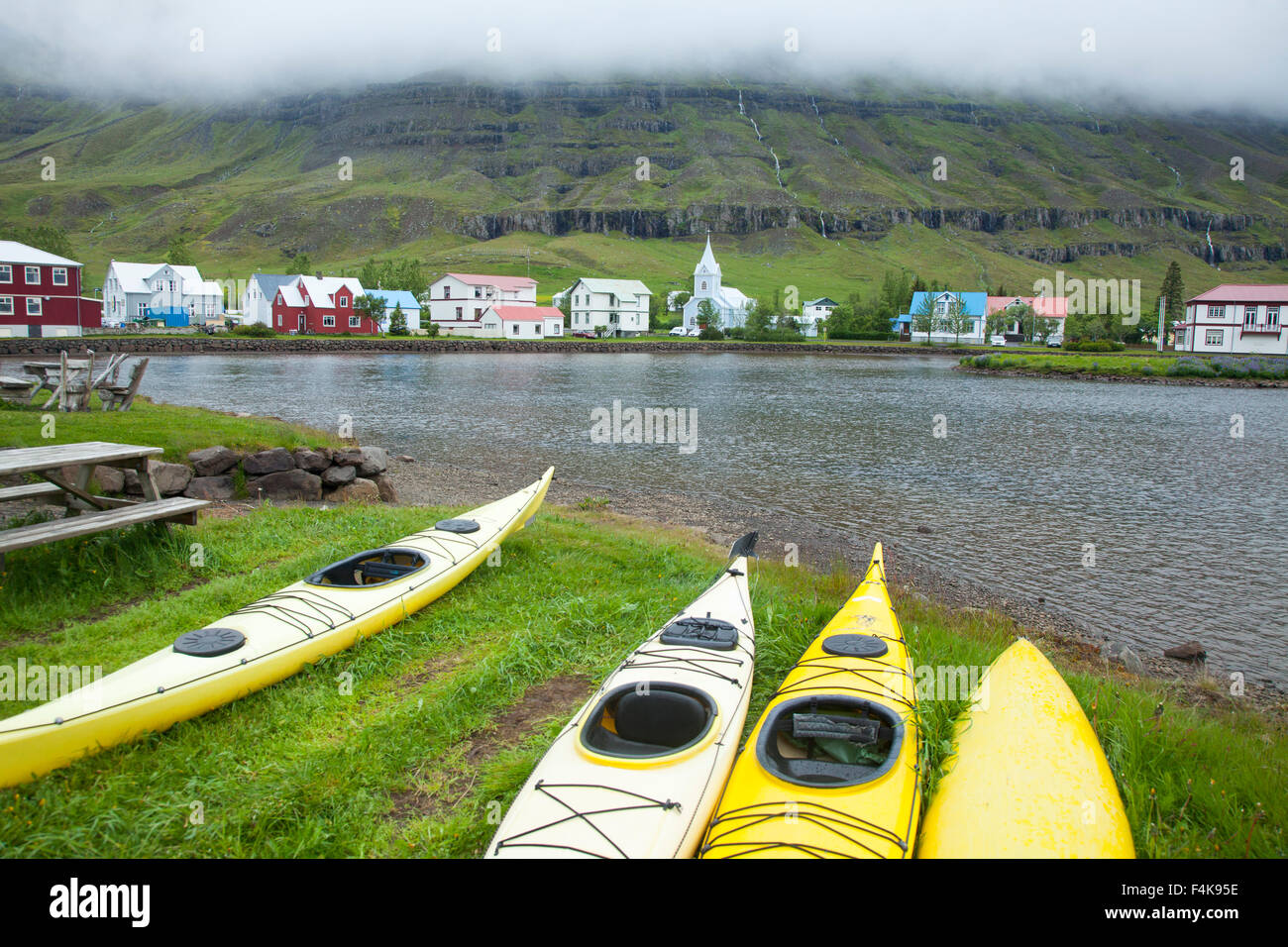 Sea kayaks on the shore of Seydisfjordur, Seydisfjordur village, Austurland, Iceland. Stock Photo