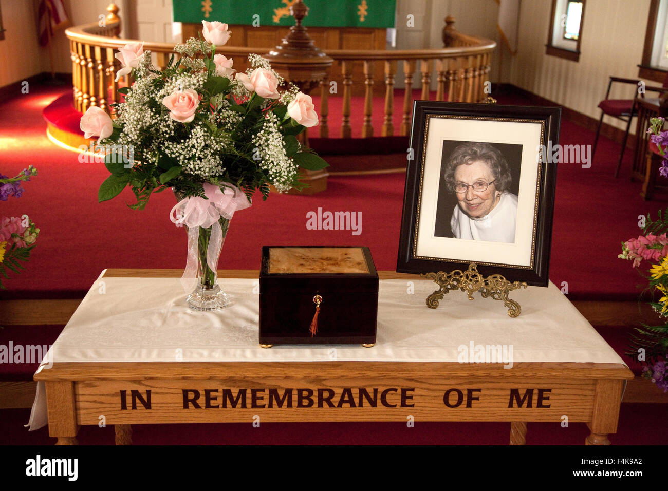 My mother's picture and ashes on a table at her funeral in the church. Vining Minnesota MN USA Stock Photo