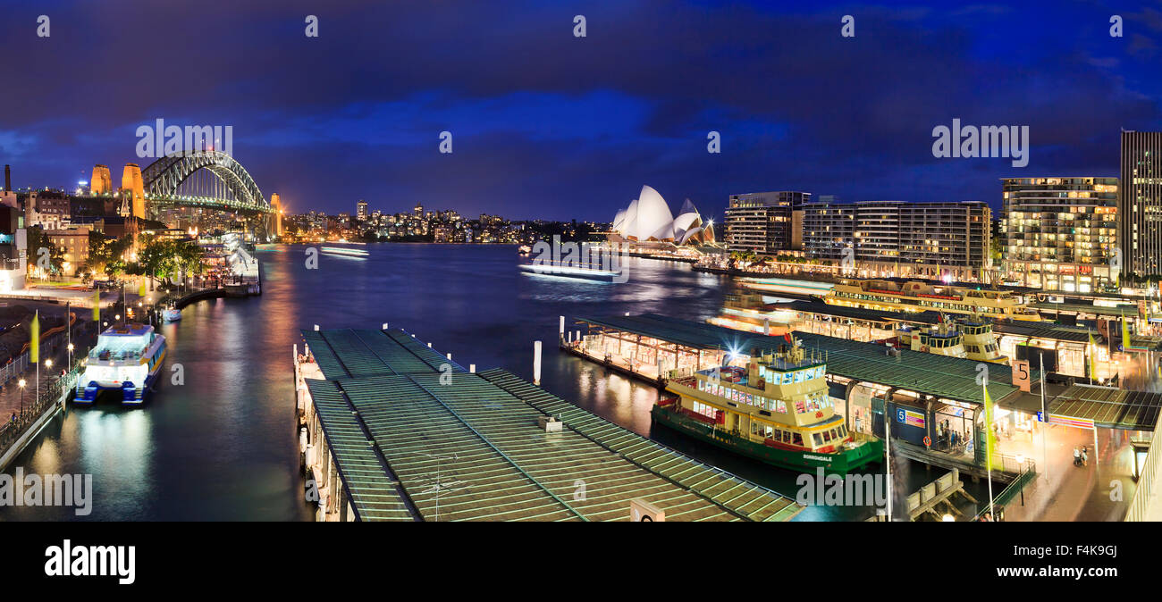 Sydney, NSW, AUstralia - April 7, 2012: City's iconic place with famous Opera House, Harbour Bridge and Circular QUay at sunset Stock Photo