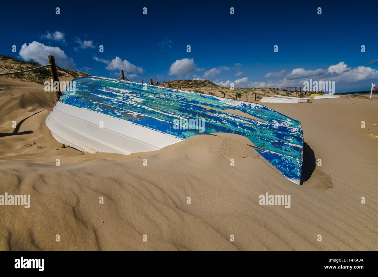 Upturned boat on beach in Guardamar, province of Alicante located at the mouth of the river Segura on the Mediterranean Sea, Costa Blanca, The Med Stock Photo