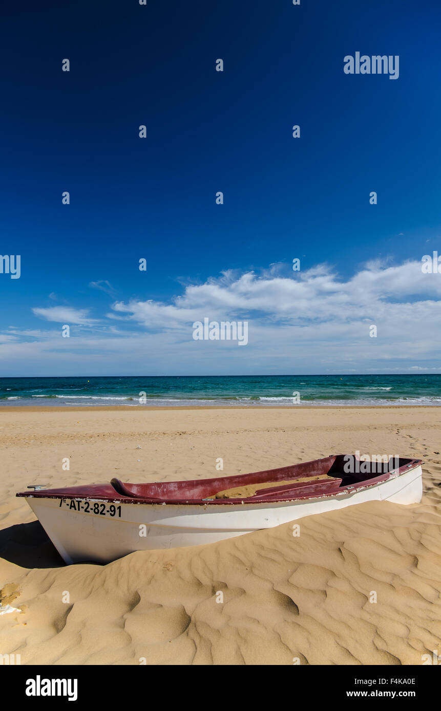 Boat on beach in Guardamar, a municipality of the province of Alicante located at the mouth of the river Segura on the Mediterranean Sea Stock Photo