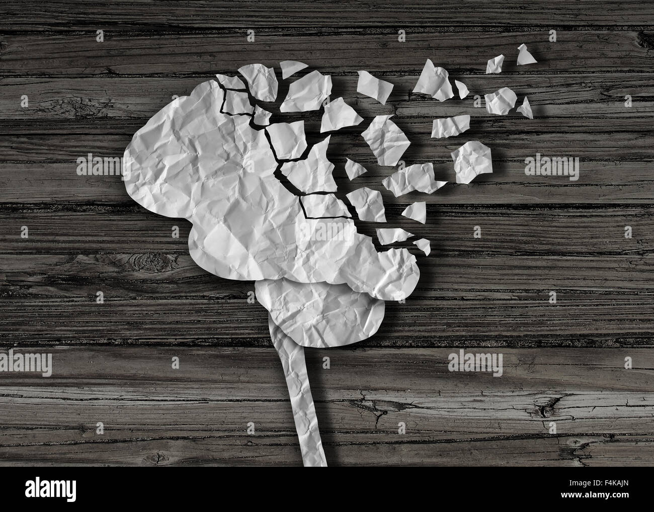 Dementia or brain damage and injury as a mental health and neurology medical symbol with a thinking human organ made of crumpled Stock Photo