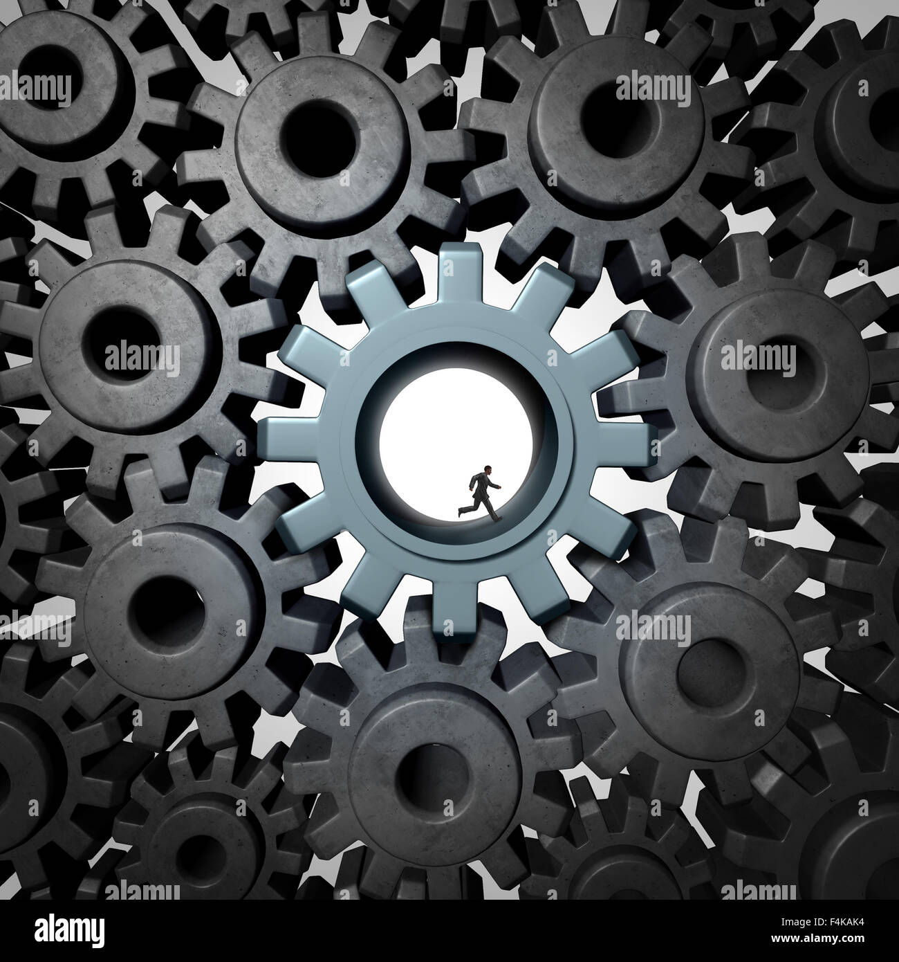 Businessman gear run concept as giant gears or cog wheels inside a network of machine parts being moved by a small person as a financial concept for economic engine or overworked essential employee productivity. Stock Photo