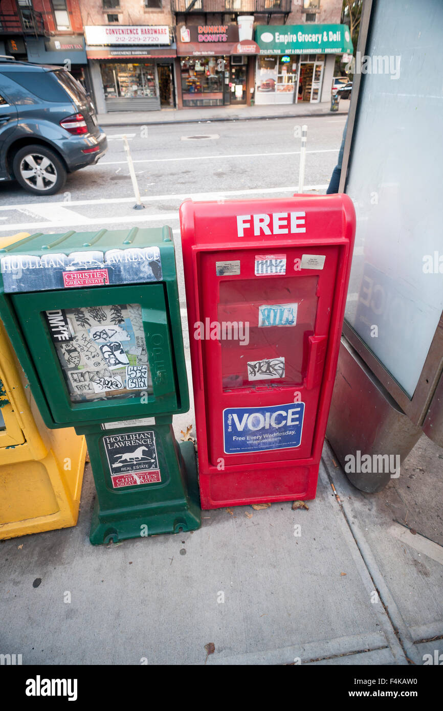 A Village Voice distribution box is seen with other newspaper boxes