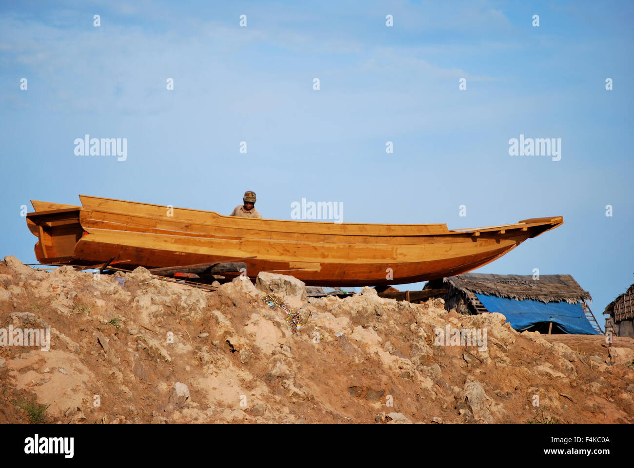 Small fishing boat out of the water at the Floating Villages on Tonle Sap River, Cambodia Stock Photo