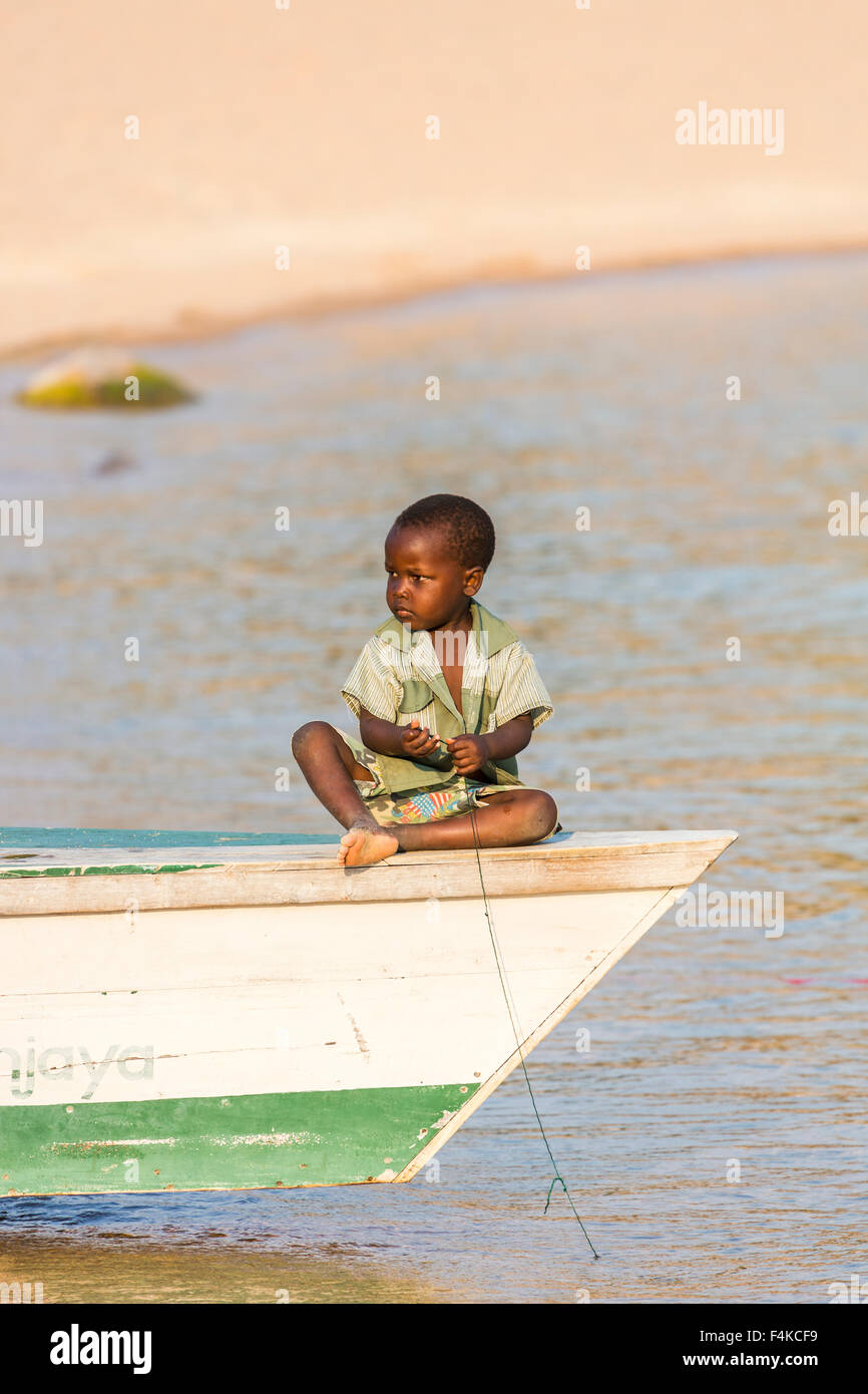 Local African boy playing at fishing from a fishing boat, Kaya Mawa, Likoma Island, Lake Malawi, Malawi, south-east Africa Stock Photo