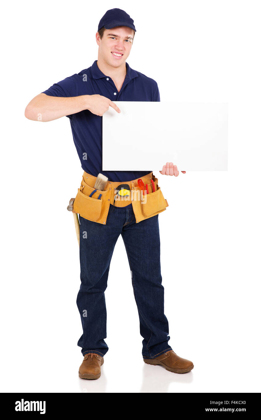 happy young handyman pointing at blank white board over white background Stock Photo