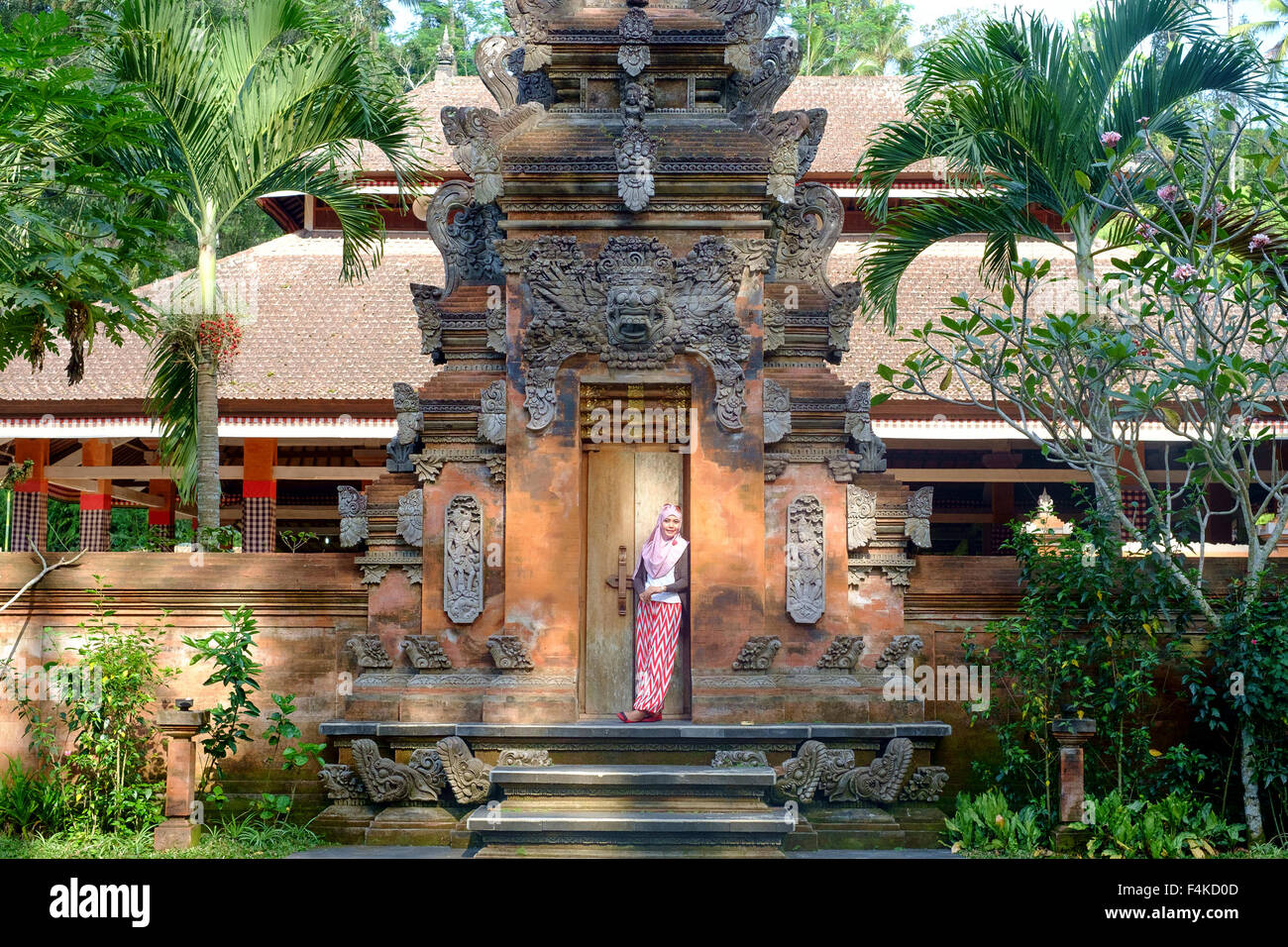 Tourist giving a post in one of the small temple in district Ubud during the religious ceremony. Stock Photo