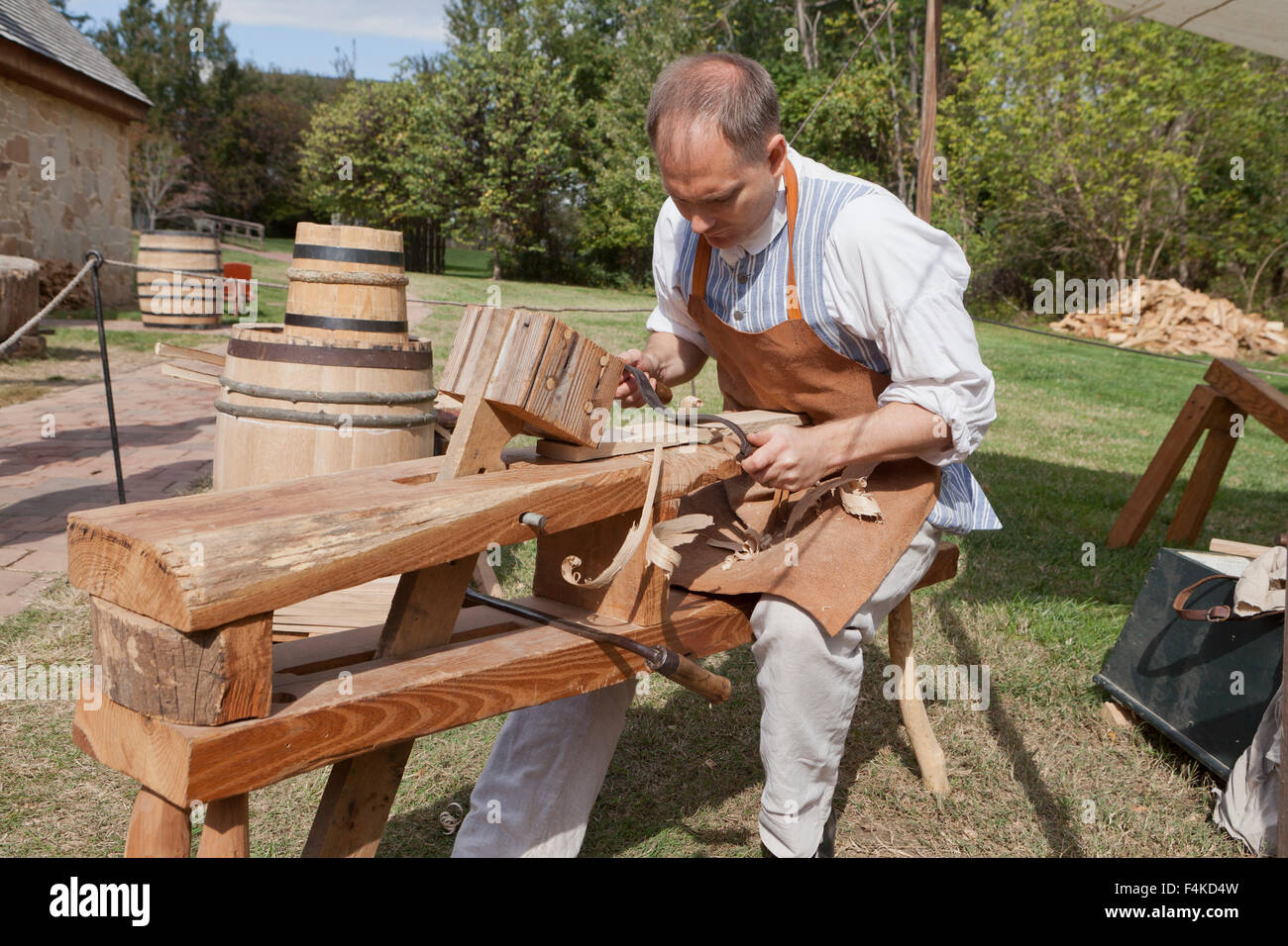 18th century cooper shaping a stave for use on a wooden cask - Mount Vernon, Alexandria, Virginia USA Stock Photo