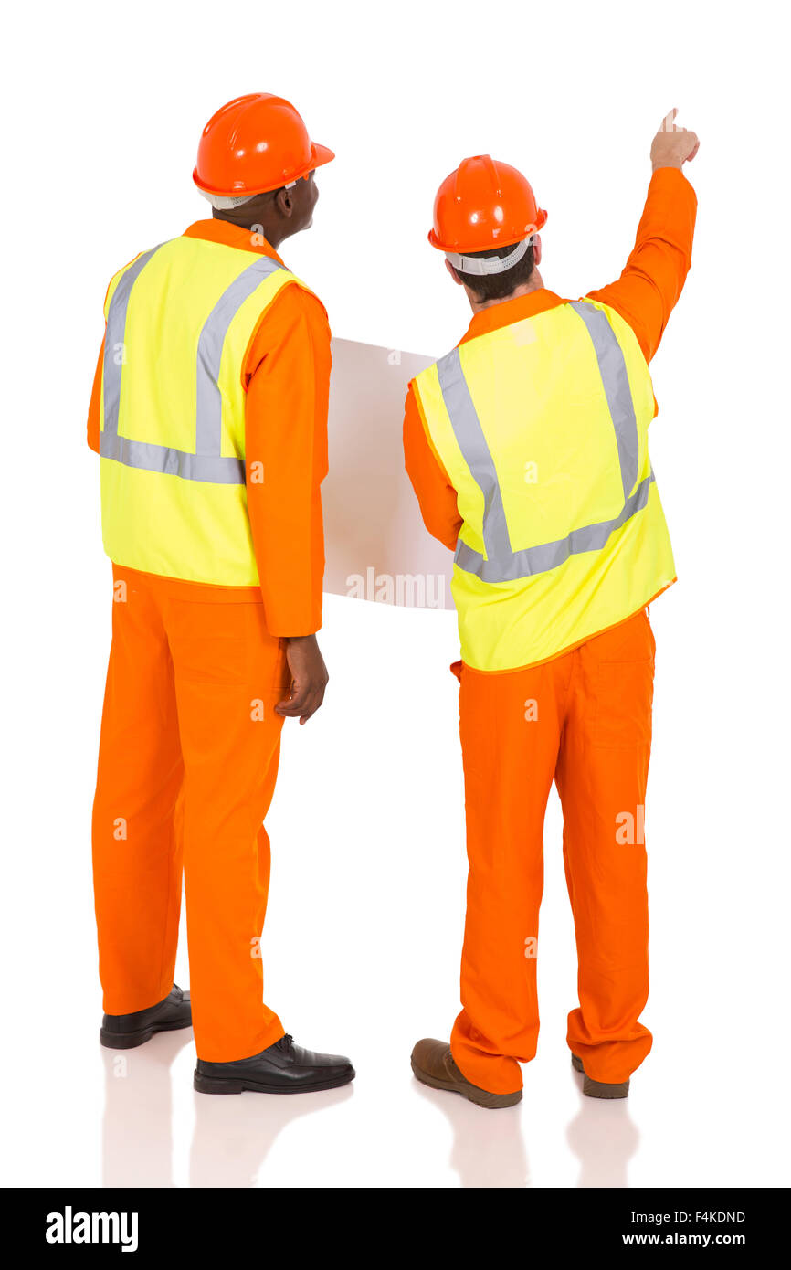 rear view of construction co-worker pointing on white background Stock Photo