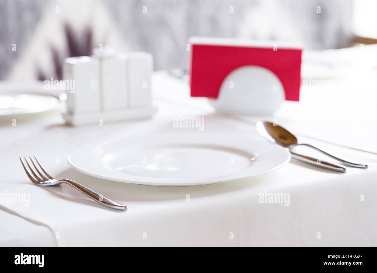White plate with metal cutlery to serve a table Stock Photo Alamy