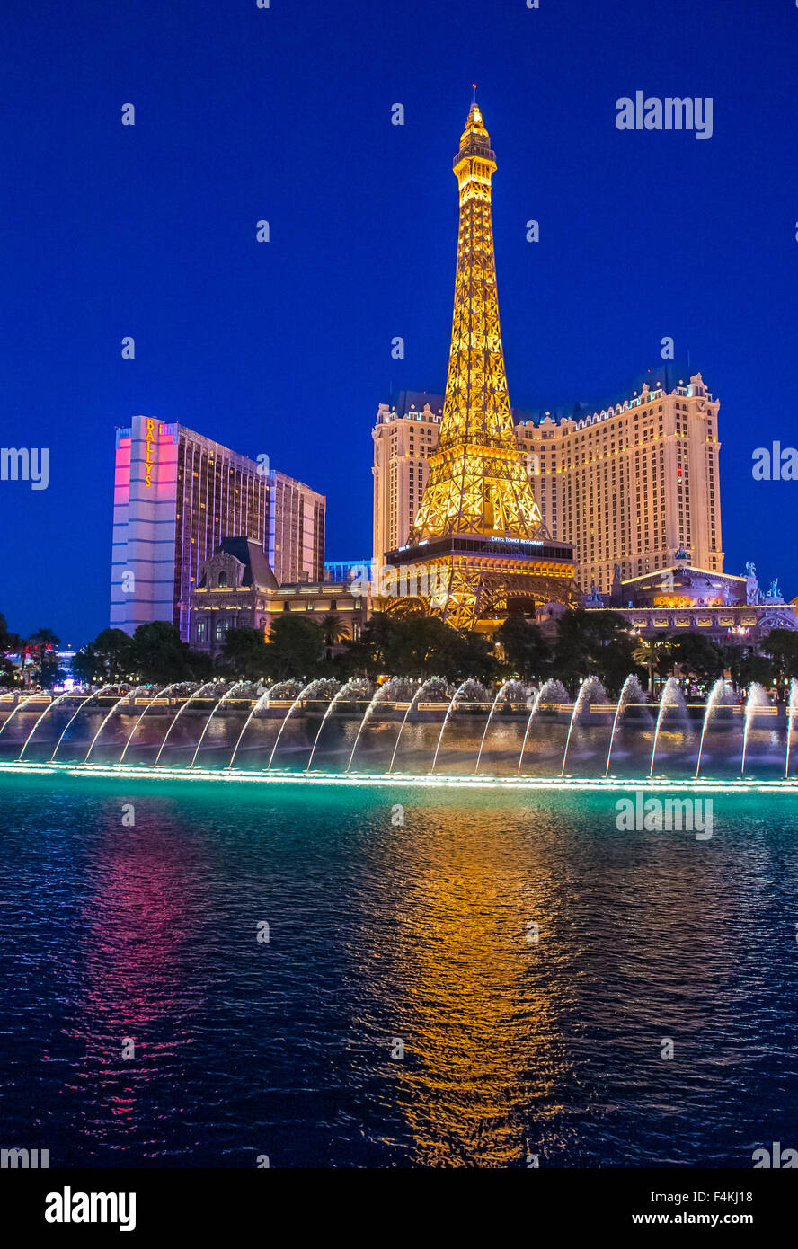 Night view of the dancing fountains of Bellagio and the Eiffel Tower