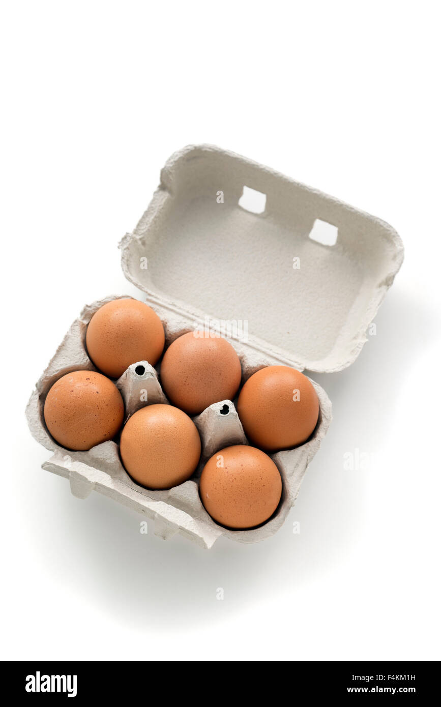 half a dozen eggs in an egg carton. isolated on white background Stock Photo