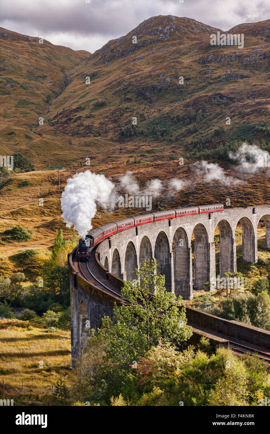 The Jacobite steam train blows steam from the exhaust as it crosses the Glenfinnan Viaduct, Highland, Scotland, UK. Stock Photo