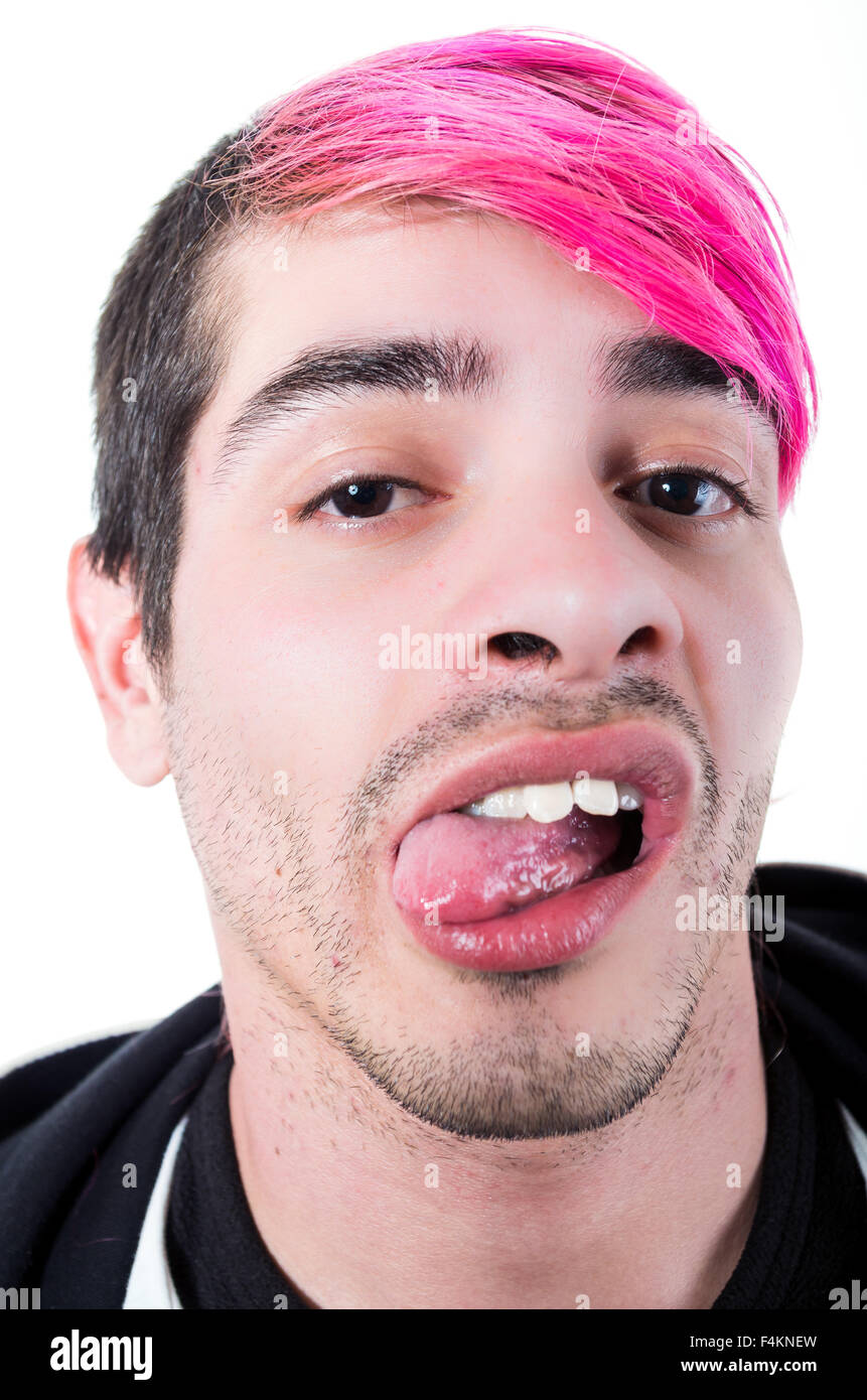 Headshot hispanic young adult with pink hair and black hoodie sweater posing for camera making facial expressions Stock Photo