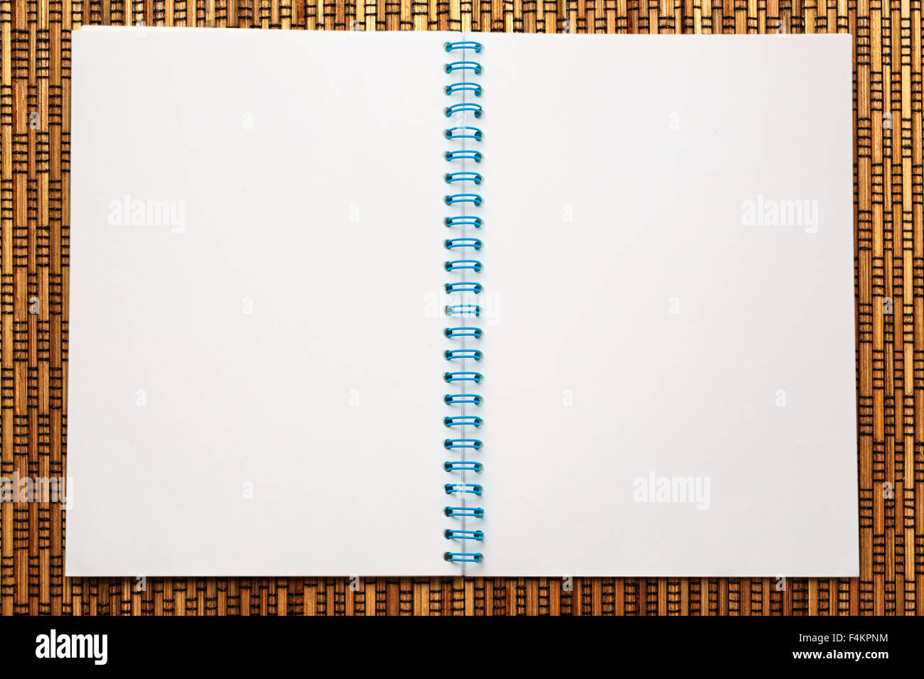 One open blank notebook on straw weaving background Stock Photo - Alamy