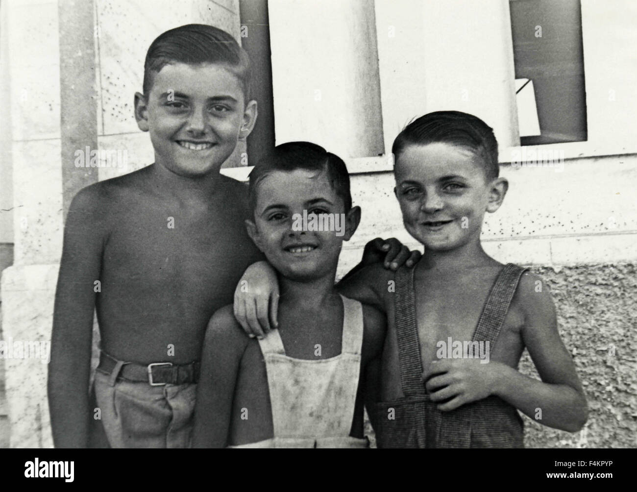 Three children embraced, Italy Stock Photo - Alamy