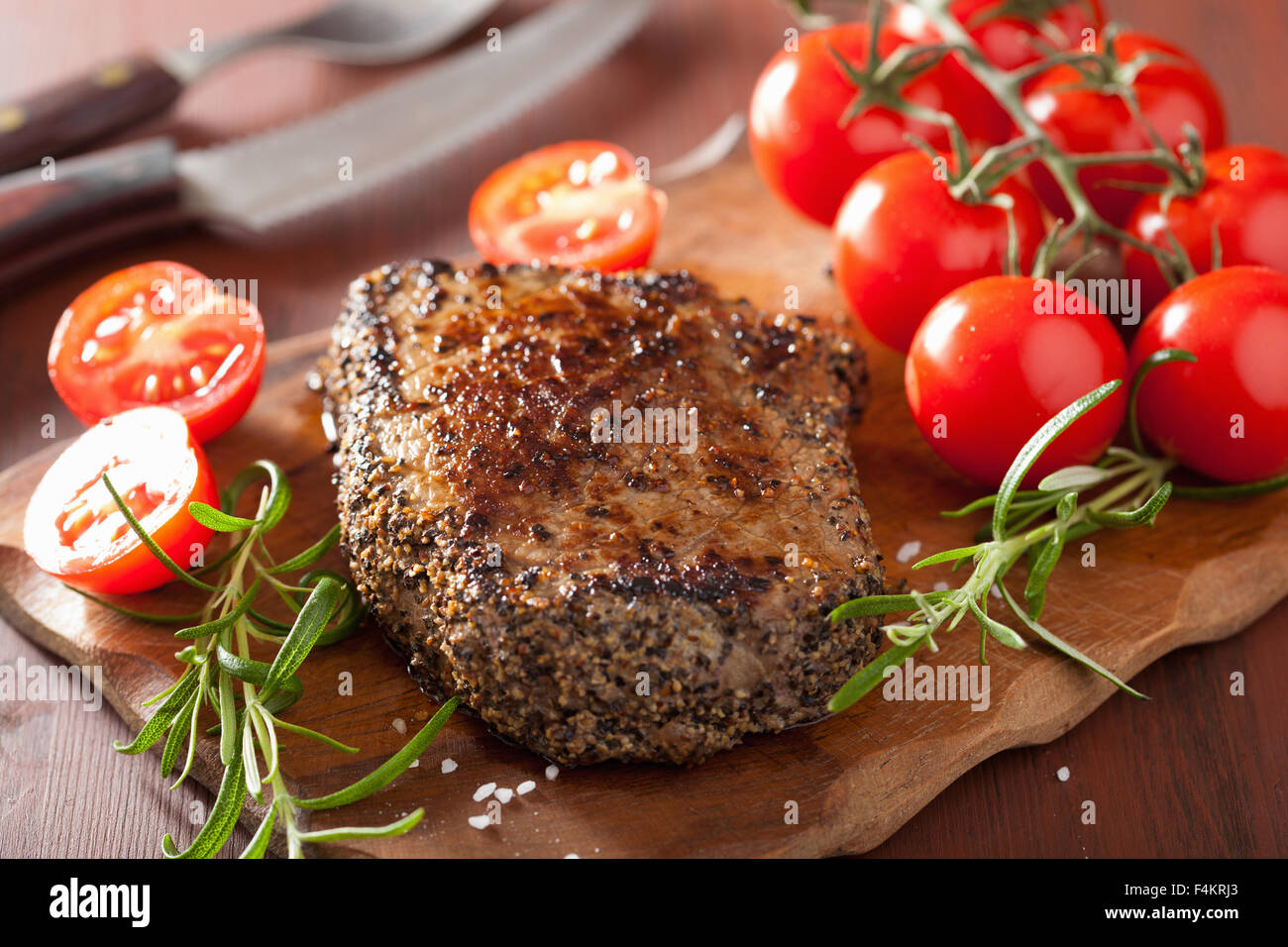 beef steak with spices and rosemary on wooden background Stock Photo