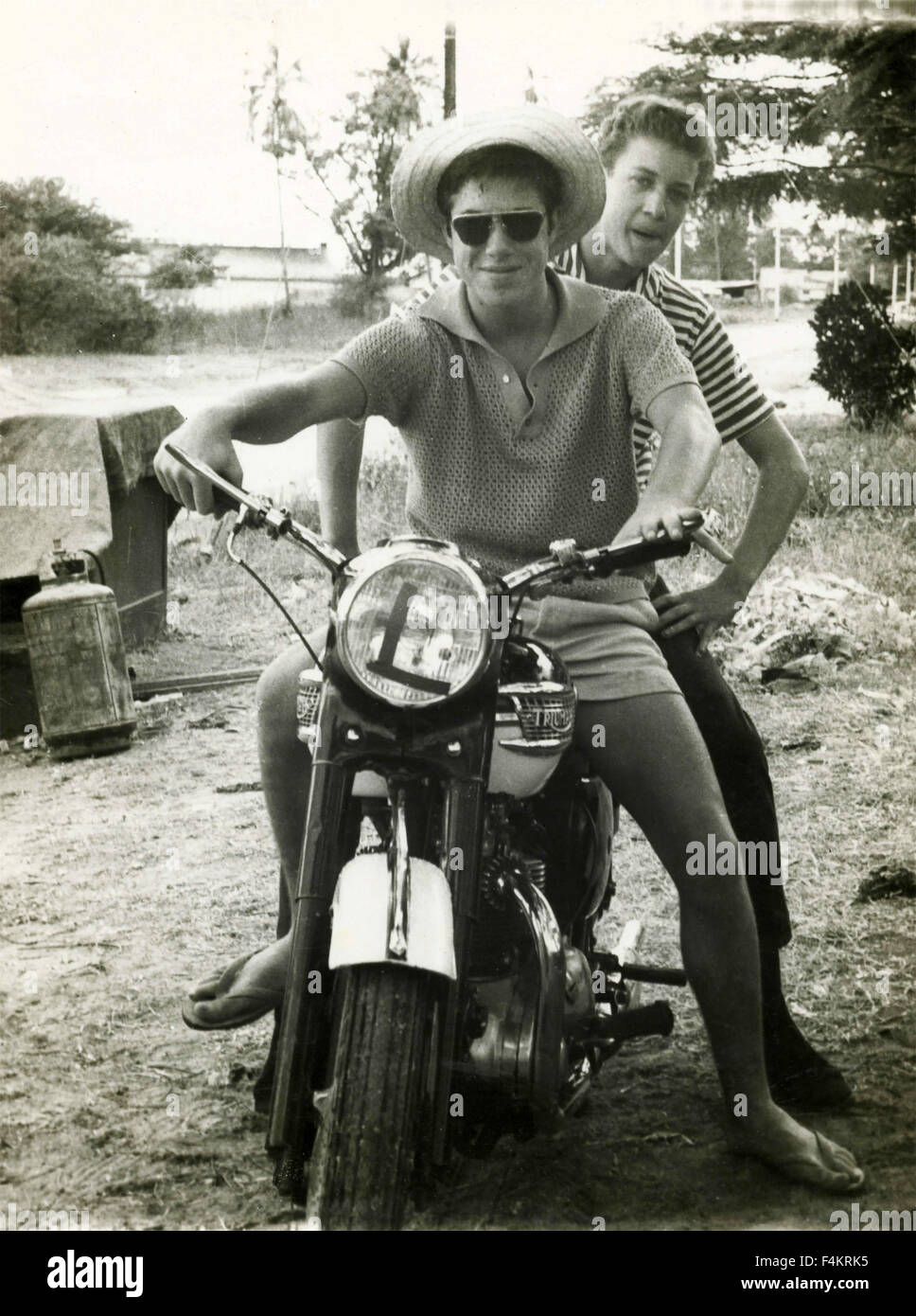 Two boys on a Triumph Bonneville motorbike, Italy Stock Photo