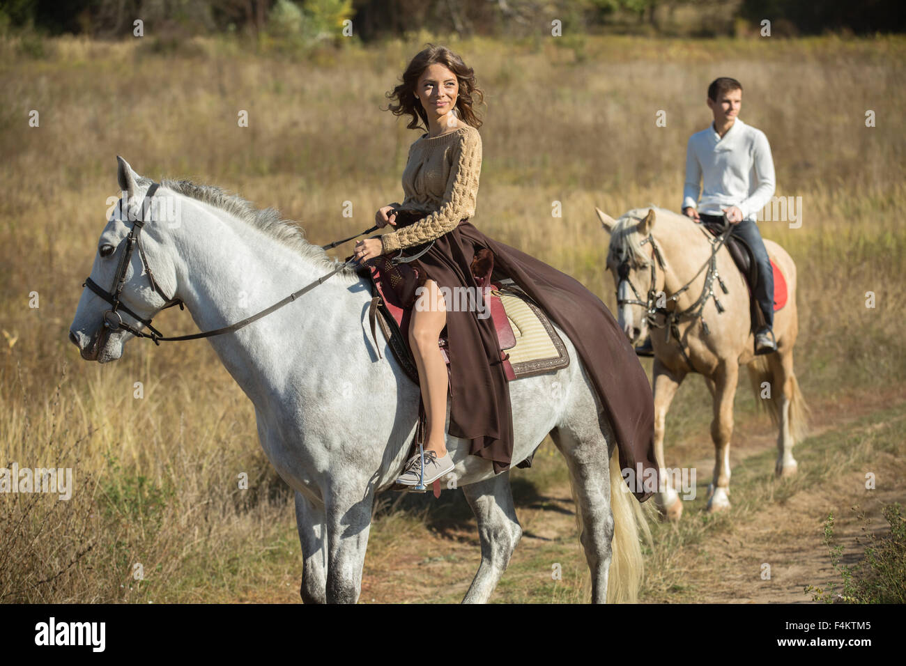 Two People Riding A Horse Together Goimages Inc