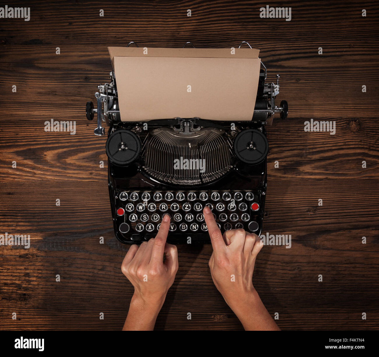 Woman typing on an old typewriter Stock Photo
