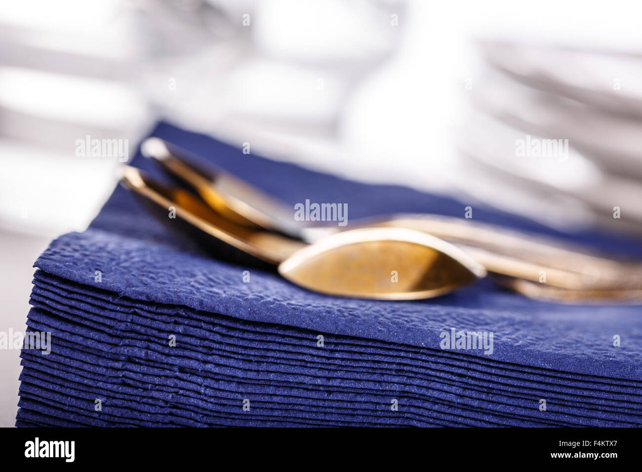 Stack of dark blue paper napkins with spoons Stock Photo Alamy